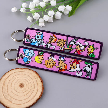 Embroidered Keychain - Cartoon Characters Scooby-Doo gang, retro robots, Humorous stick figures, and action-packed dinosaurs and warriors.