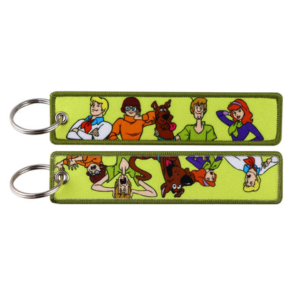 Embroidered Keychain - Cartoon Characters Scooby-Doo gang, retro robots, Humorous stick figures, and action-packed dinosaurs and warriors.
