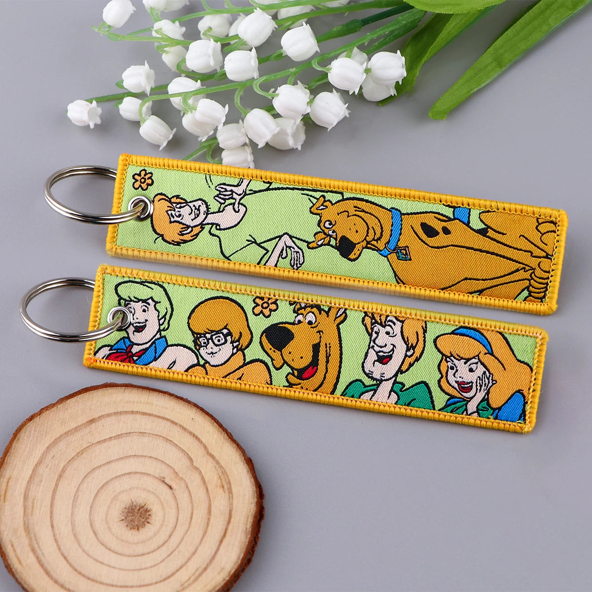Embroidered Keychain - Cartoon Characters Scooby-Doo gang, retro robots, Humorous stick figures, and action-packed dinosaurs and warriors.