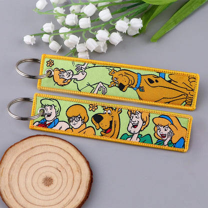 Embroidered Keychain - Cartoon Characters Scooby-Doo gang, retro robots, Humorous stick figures, and action-packed dinosaurs and warriors.